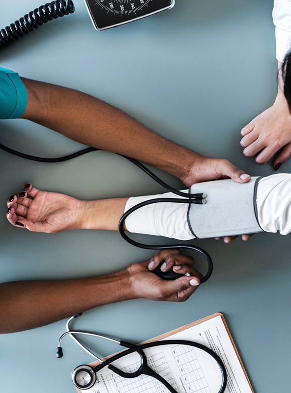 Blood Pressure Checkup in Medical Setting with Stethoscope and Healthcare Tools