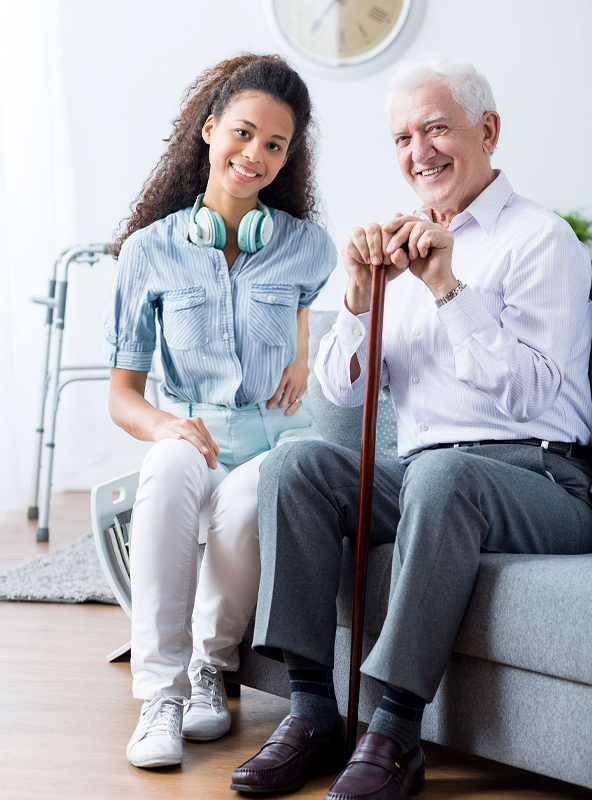 Elderly Man and Young Woman Smiling in Holistic Healthcare Setting