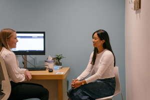 Two Women Discussing Holistic Healthcare in a Modern Office Setting